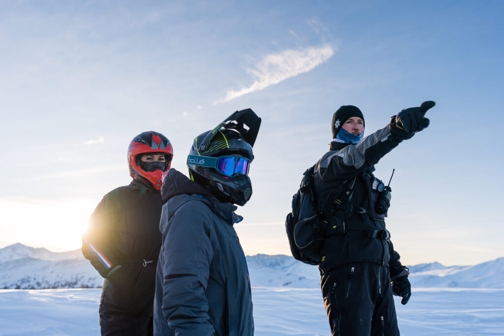 Snowmobile tour guide and guests sightseeing